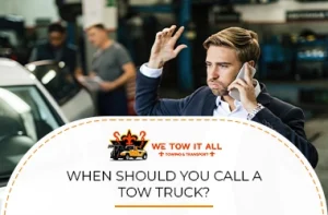 frustrated driver on phone requesting tow truck assistance beside vehicle
